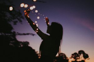 silhouette-photo-of-woman-holding-lights-3792581